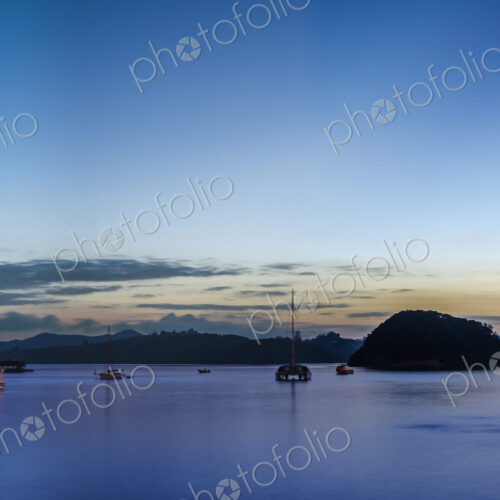 Boats sailing in bay at dawn, Bay of Islands, New Zealand Boats sailing in bay at dawn, Bay of Islands, New Zealand
