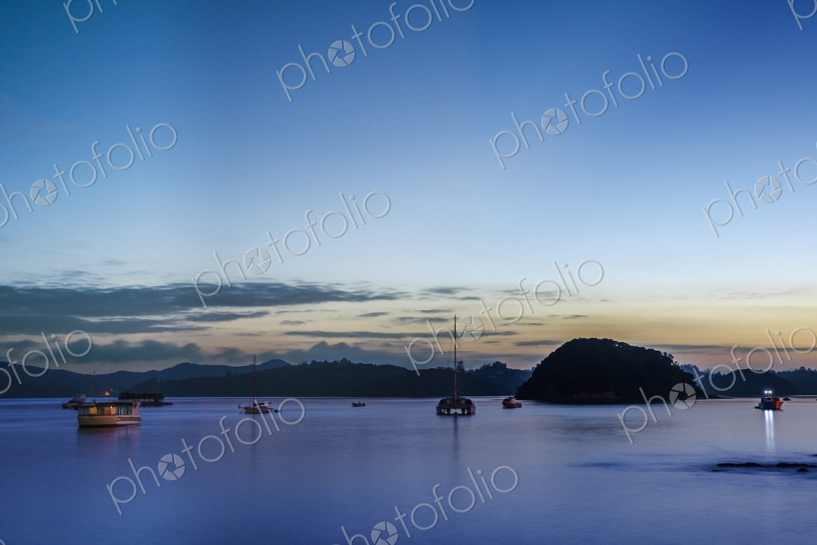 Boats sailing in bay at dawn, Bay of Islands, New Zealand