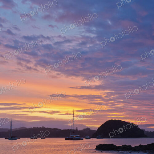 Boats sailing in bay at sunrise, Bay of Islands, Paihia, New Zealand Boats sailing in bay at sunrise, Bay of Islands, Paihia, New Zealand