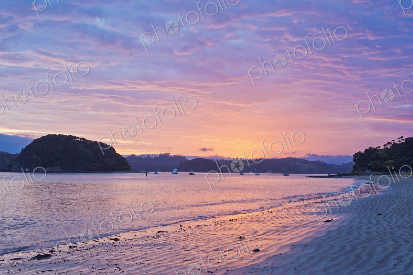 Boats sailing in bay at sunrise, Bay of Islands, Paihia, New Zealand