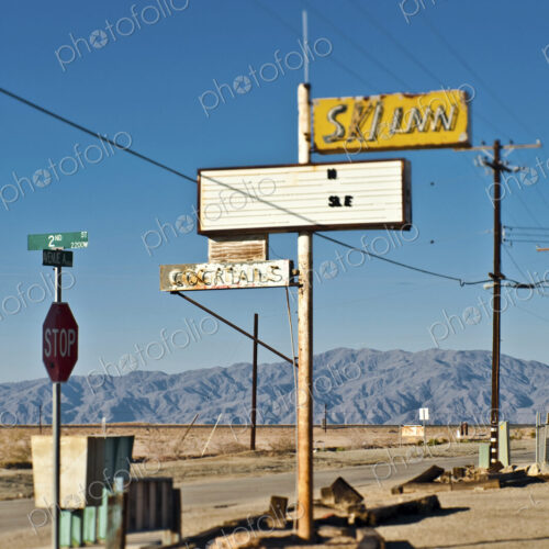 Bombay Beach, California, old neon signs, a stop sign and telephone wires and pole.… Bombay Beach, California, old neon signs, a stop sign and telephone wires and pole.…