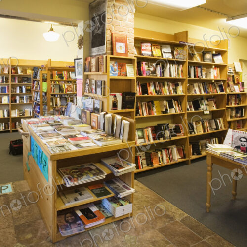 Books on shelves and tables in bookstore Books on shelves and tables in bookstore