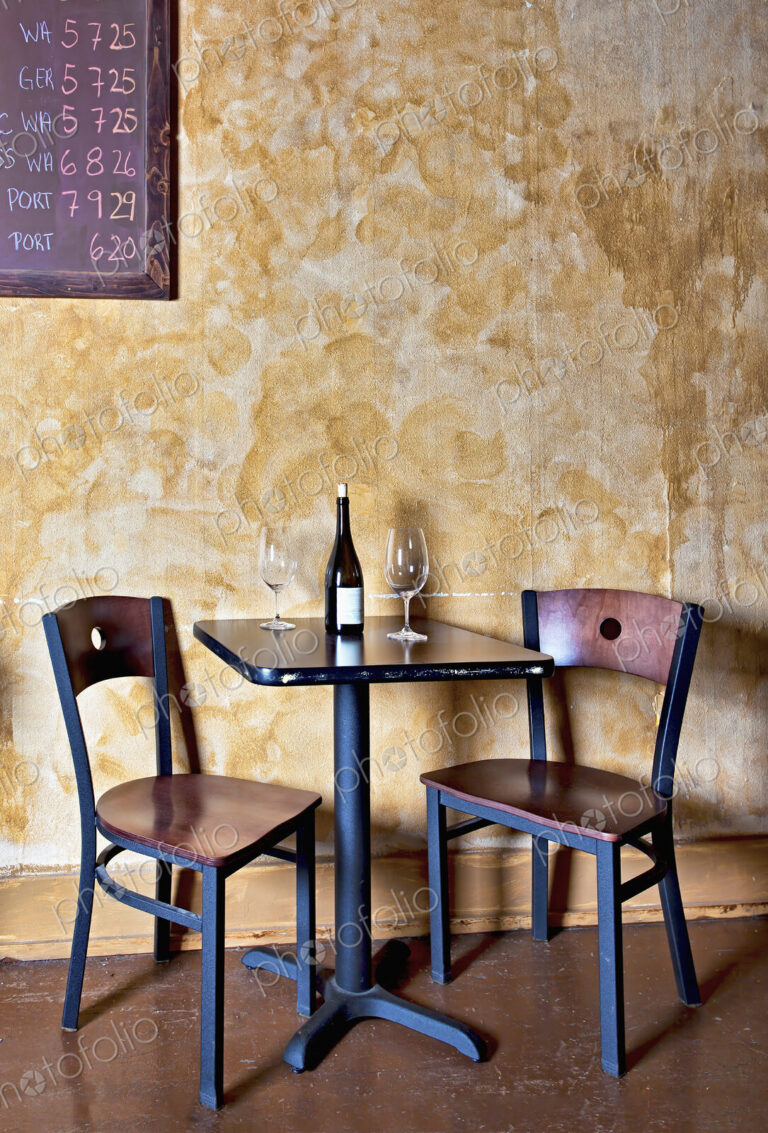 Bottle of wine and glasses on table in wine bar
