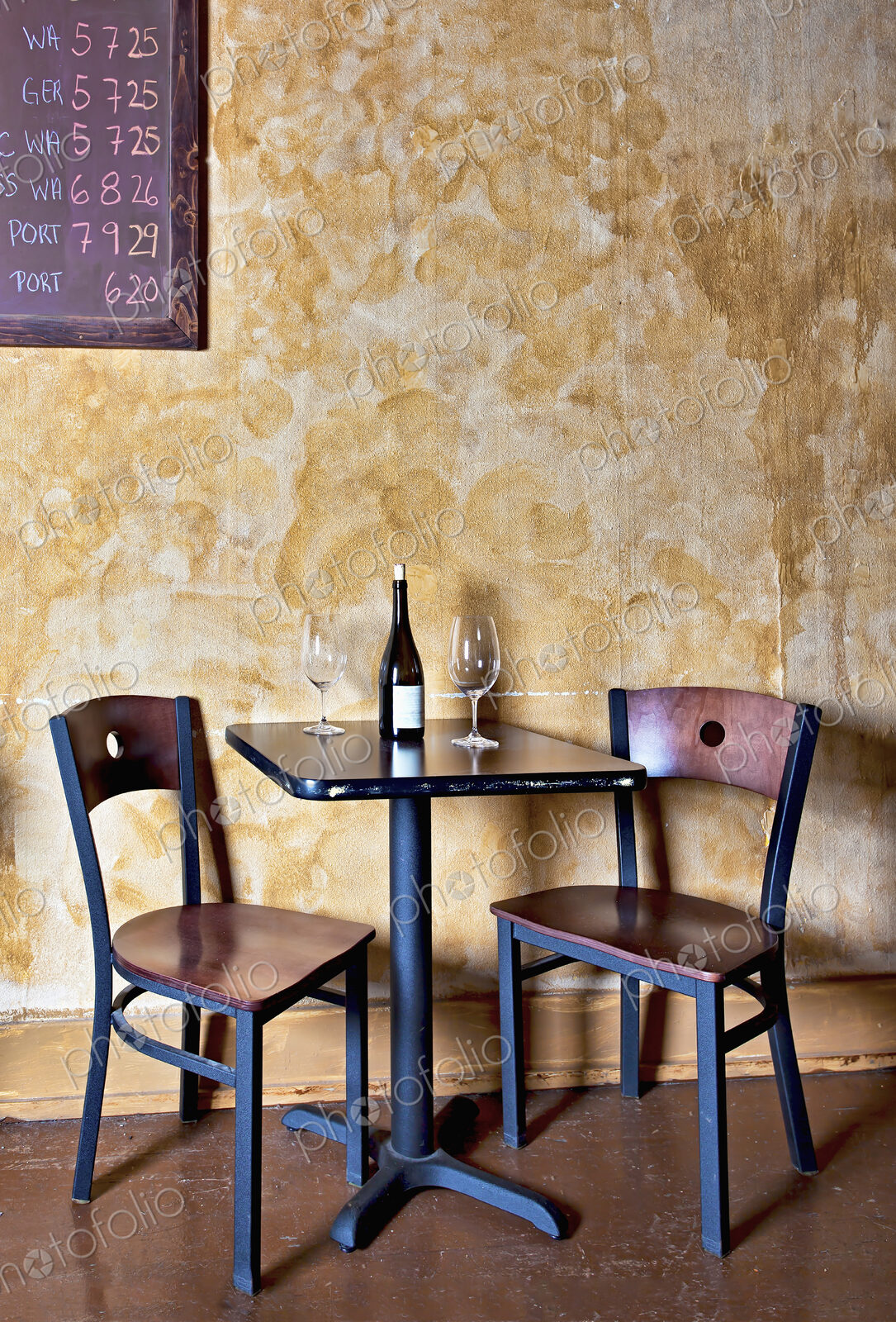 Bottle of wine and glasses on table in wine bar