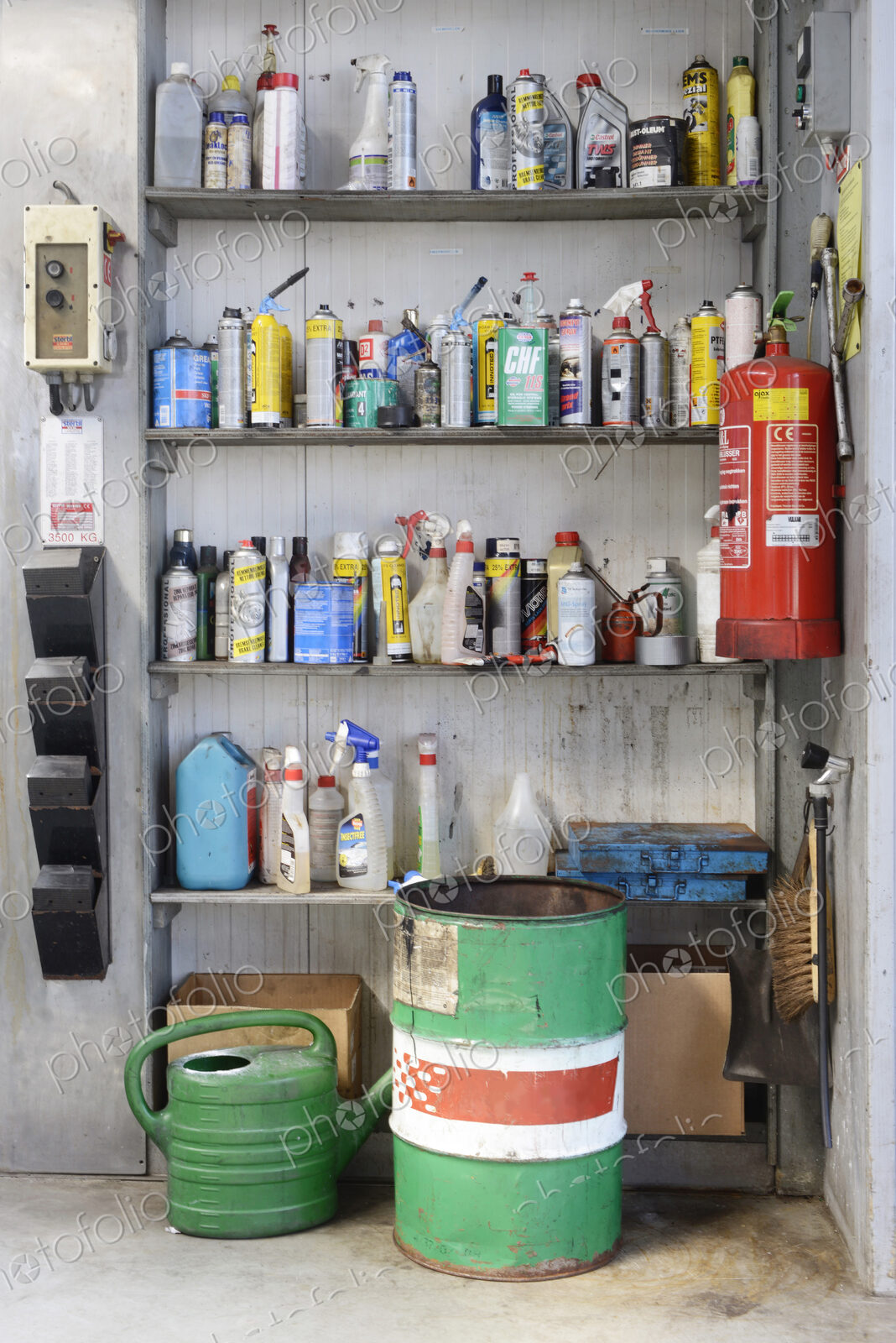 Bottles of liquids on shelf in auto garage shop.