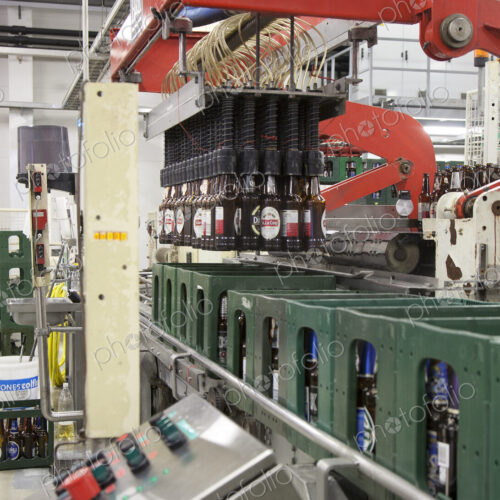 Bottling plant with moving belts, rows of bottles, automated process, capping and… Bottling plant with moving belts, rows of bottles, automated process, capping and…