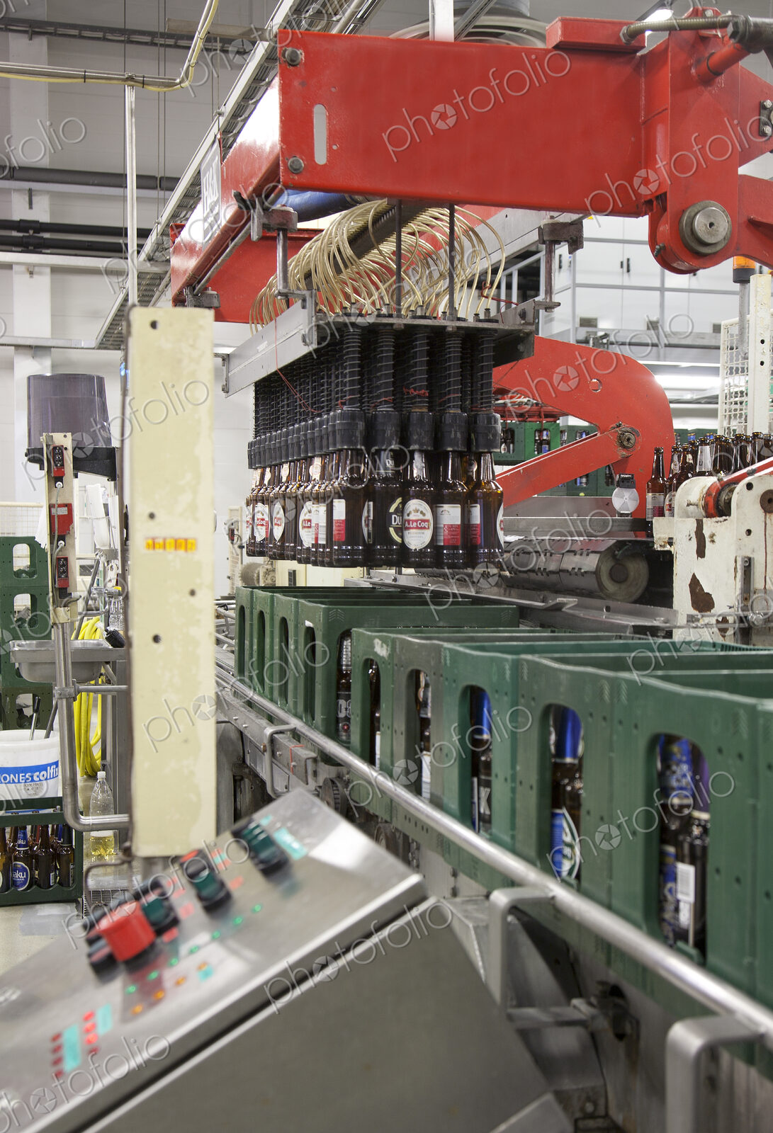 Bottling plant with moving belts, rows of bottles, automated process, capping and…