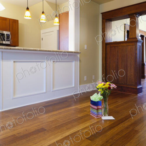 Bouquet of flowers and gift in new house