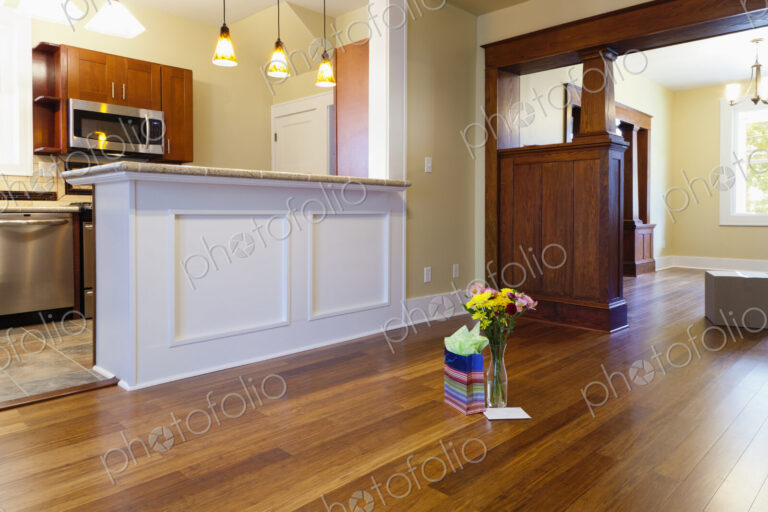 Bouquet of flowers and gift in new house