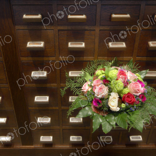 Bouquet of flowers near apothecary drawers