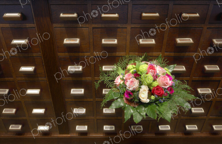 Bouquet of flowers near apothecary drawers