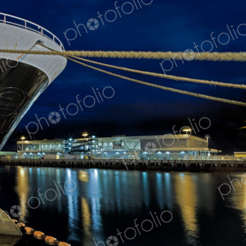 Bow of a Large Ship and Docking Ropes at Night