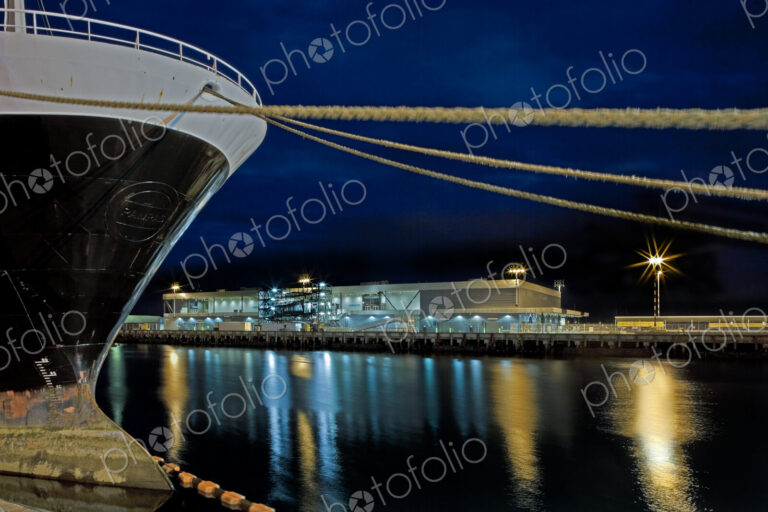 Bow of a Large Ship and Docking Ropes at Night