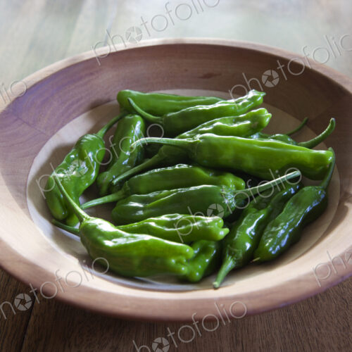 Bowl of green shishito peppers