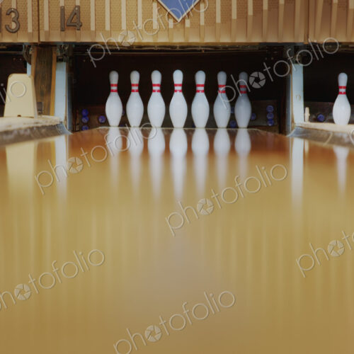 Bowling pins reflecting in bowling alley lane Bowling pins reflecting in bowling alley lane
