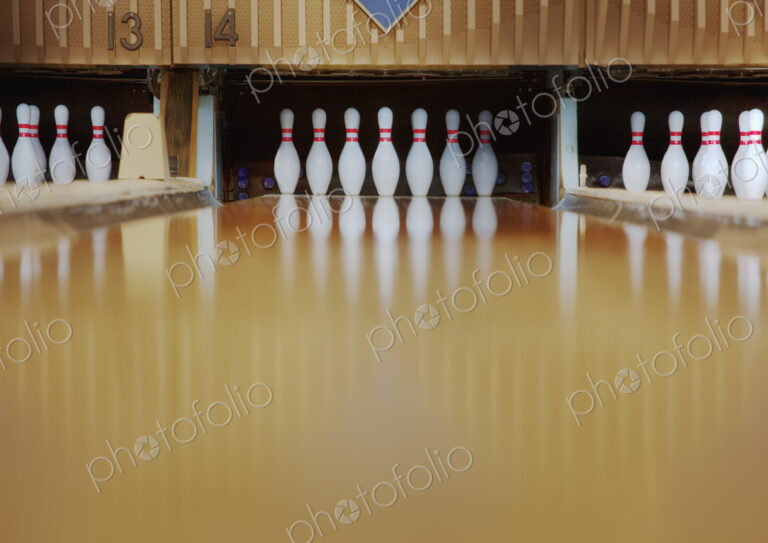 Bowling pins reflecting in bowling alley lane