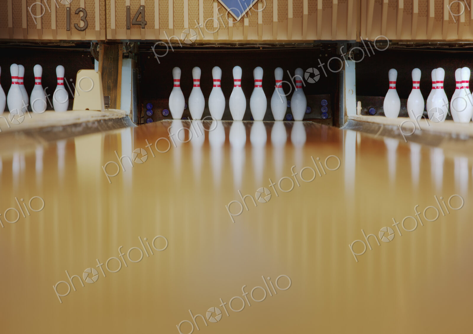 Bowling pins reflecting in bowling alley lane