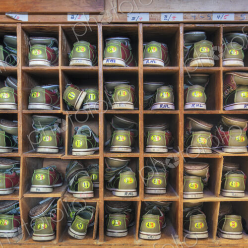 Bowling shoes stacked in cabinet