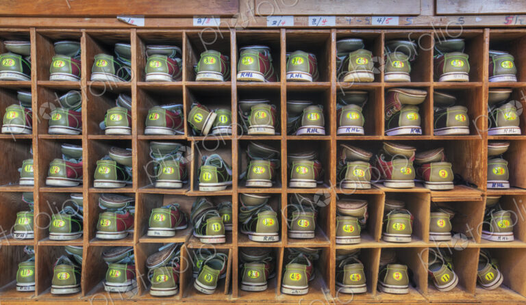 Bowling shoes stacked in cabinet