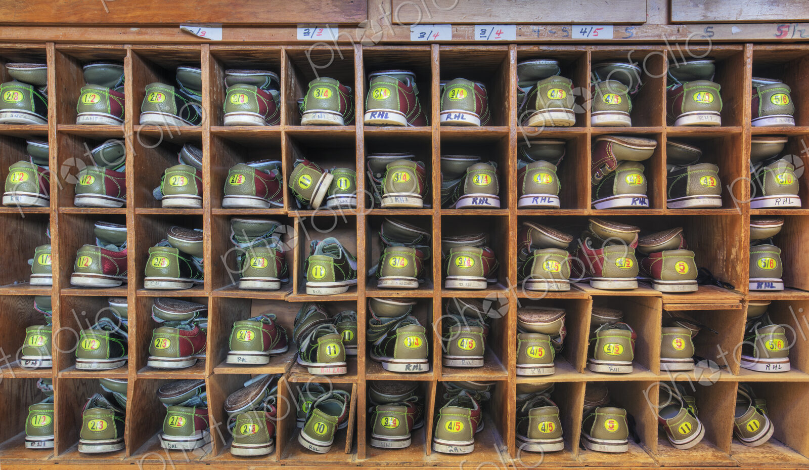 Bowling shoes stacked in cabinet