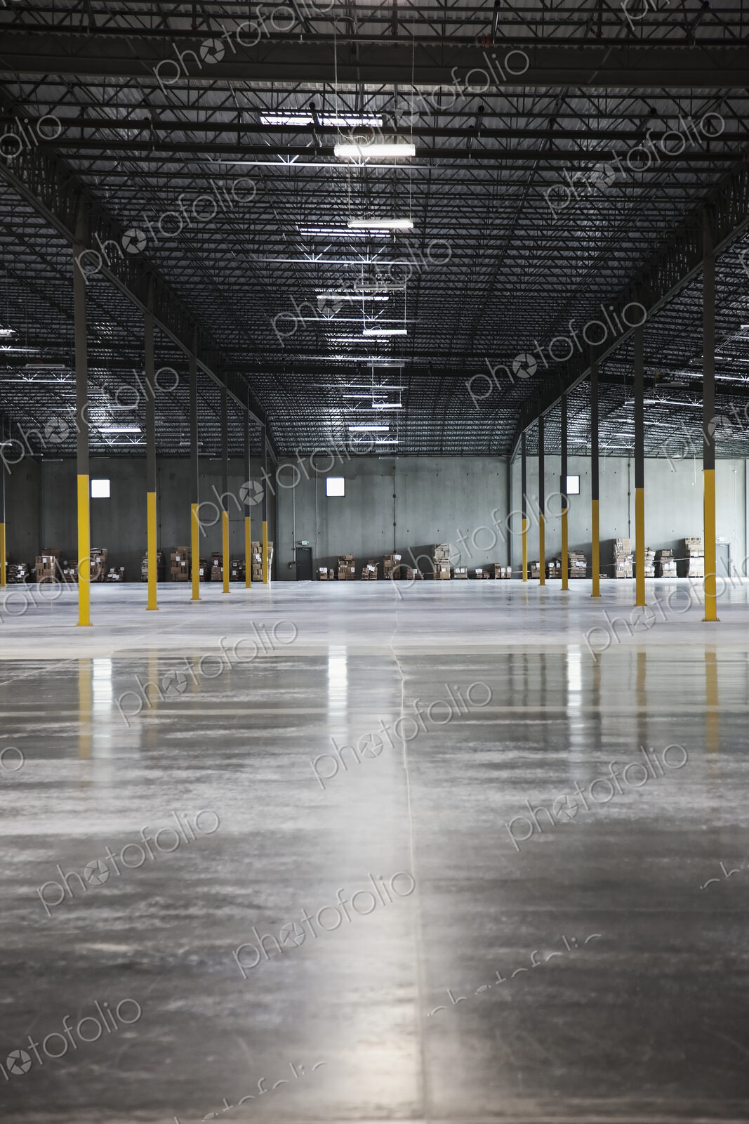 Boxes along wall in distance in warehouse