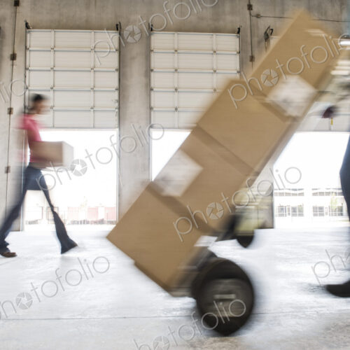 Boxes being moved into a new empty warehouse. Boxes being moved into a new empty warehouse.