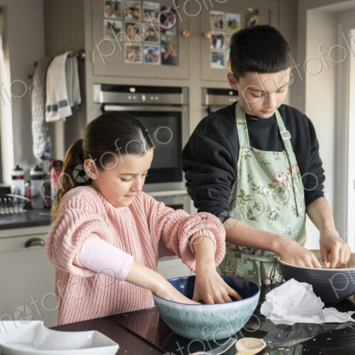 Boy and girl baking together in kitchen. Boy and girl baking together in kitchen.