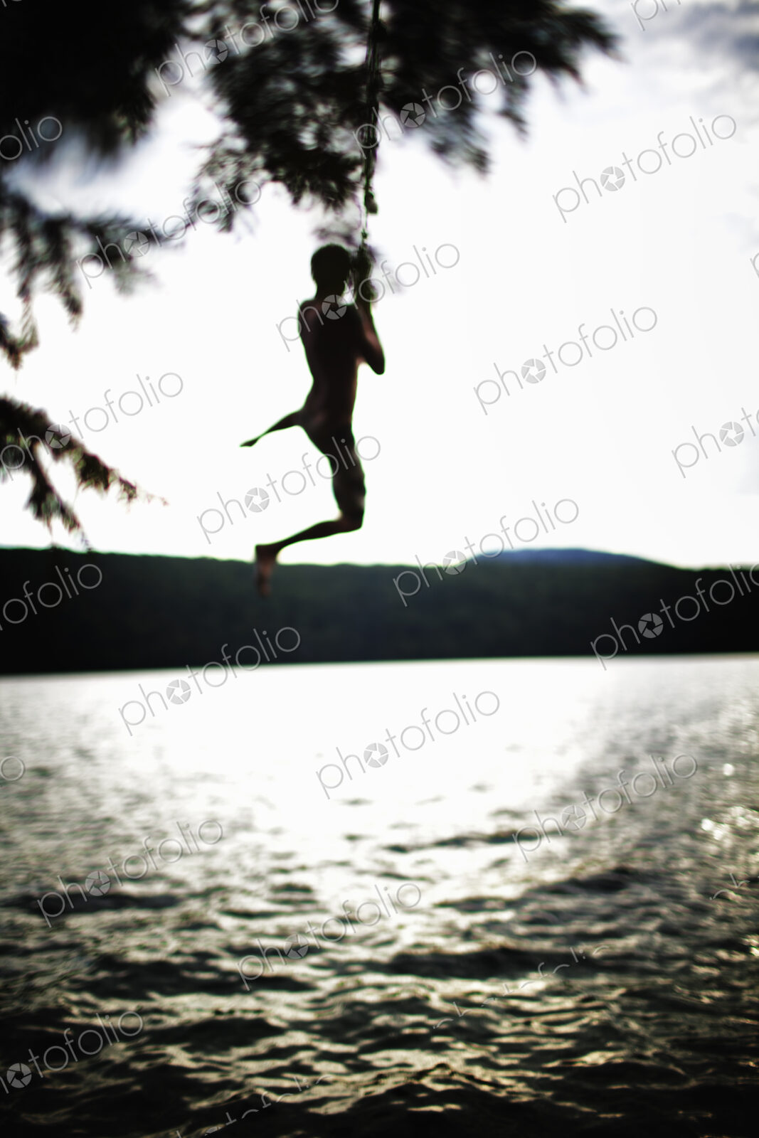 Boy jumping off rope swing