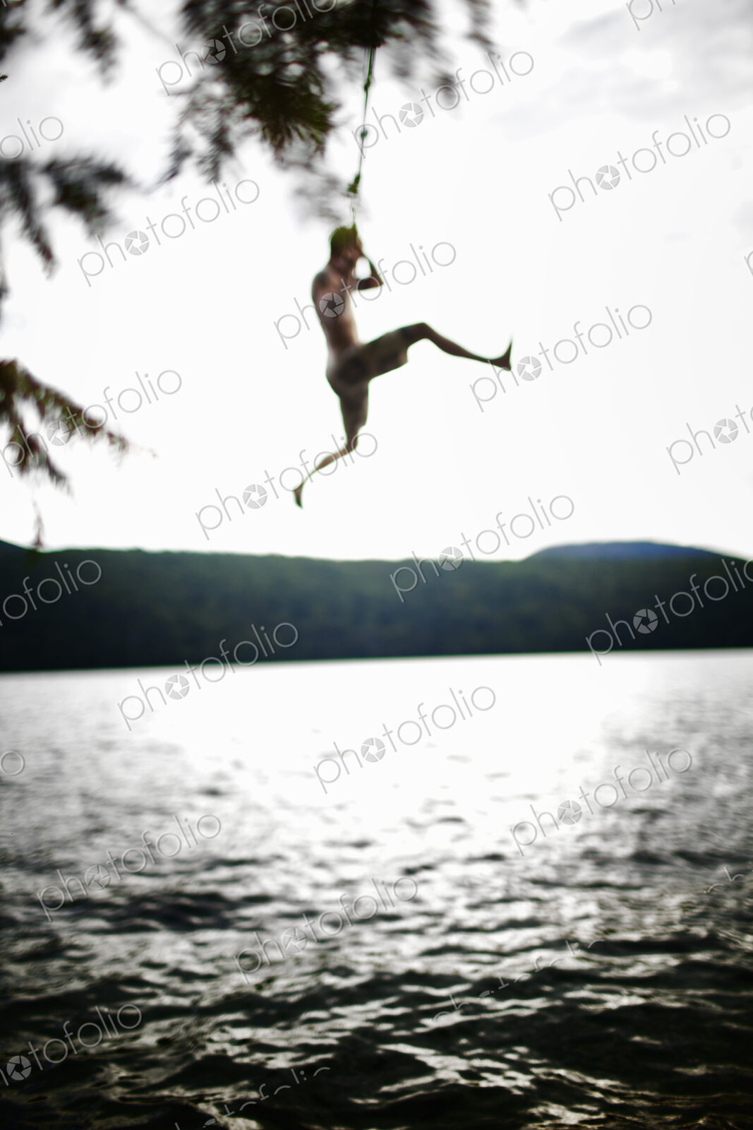 Boy jumping off rope swing