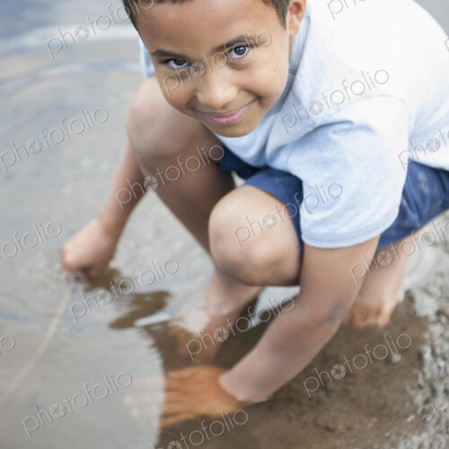 Boy playing by a lake. Boy playing by a lake.