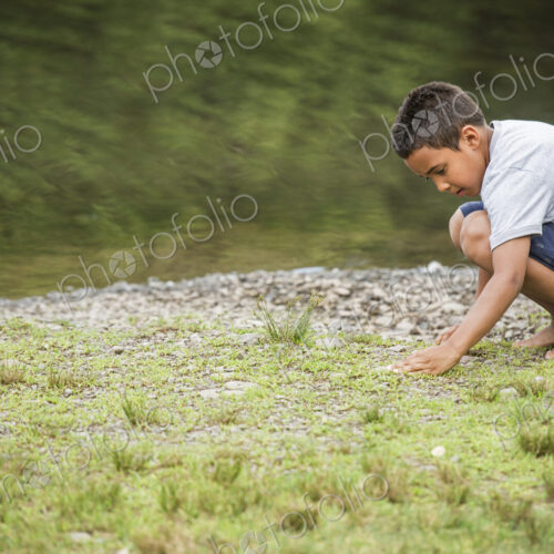 Boy playing by a lake. Boy playing by a lake.
