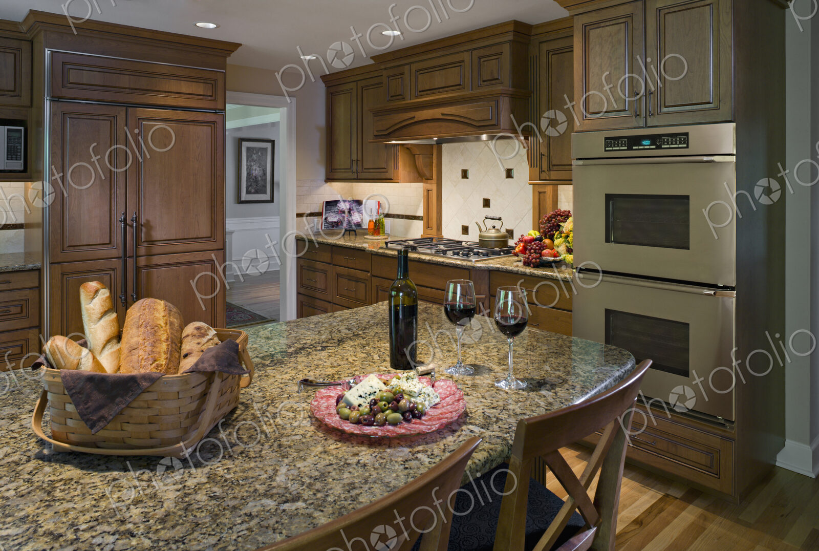Bread, plate of cheese and olives with wine in kitchen