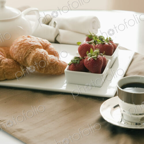 Breakfast Setting on Table, croissants and jam Breakfast Setting on Table, croissants and jam