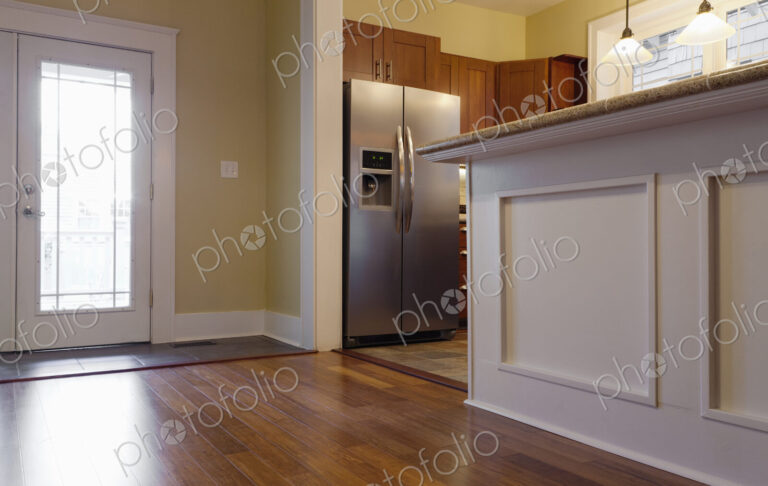Breakfast bar and refrigerator in kitchen