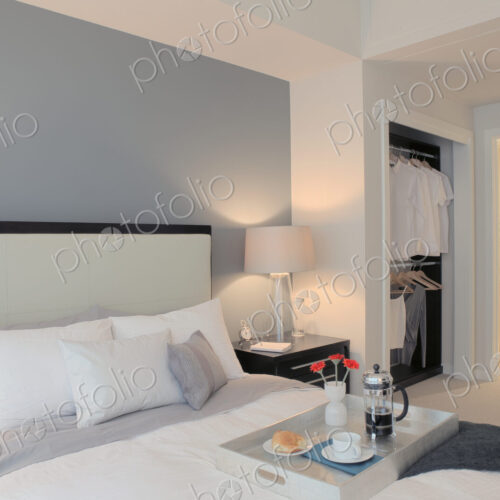 Breakfast on tray in luxury master bedroom