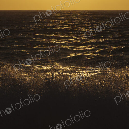 Breaking ocean waves and reflections of light on the water aqt dusk. Breaking ocean waves and reflections of light on the water aqt dusk.