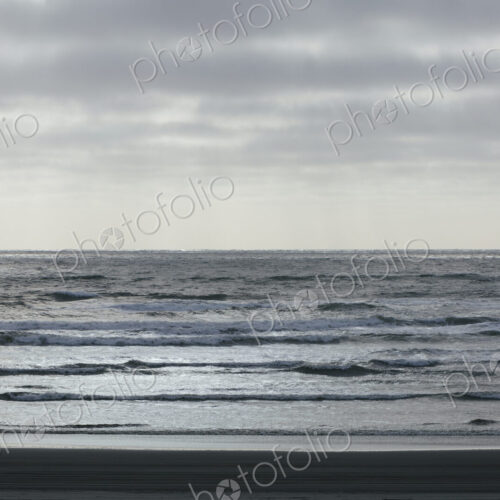 Breaking waves and moody sky at dusk Breaking waves and moody sky at dusk