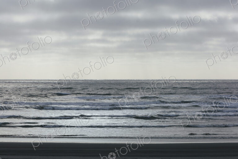 Breaking waves and moody sky at dusk