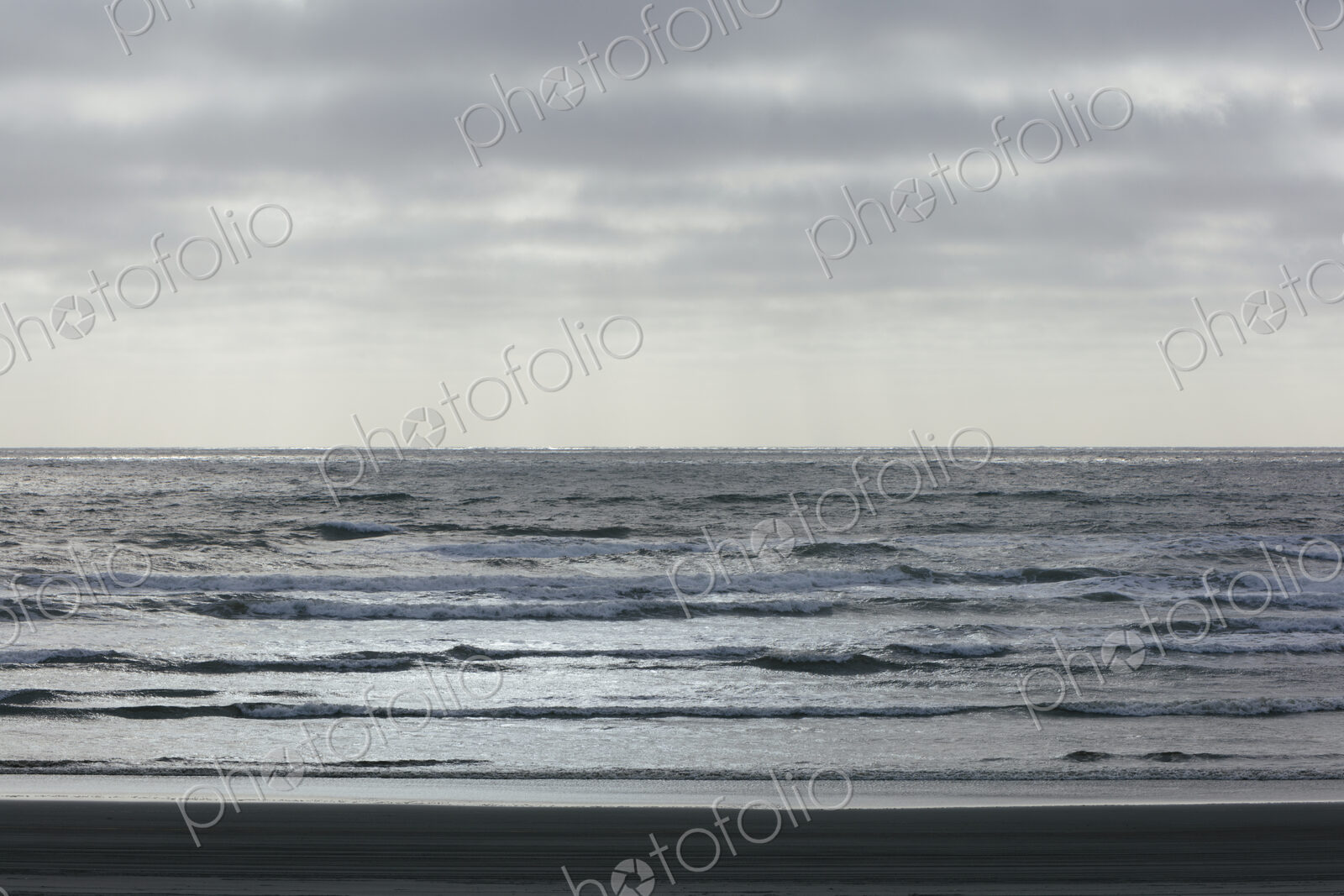 Breaking waves and moody sky at dusk