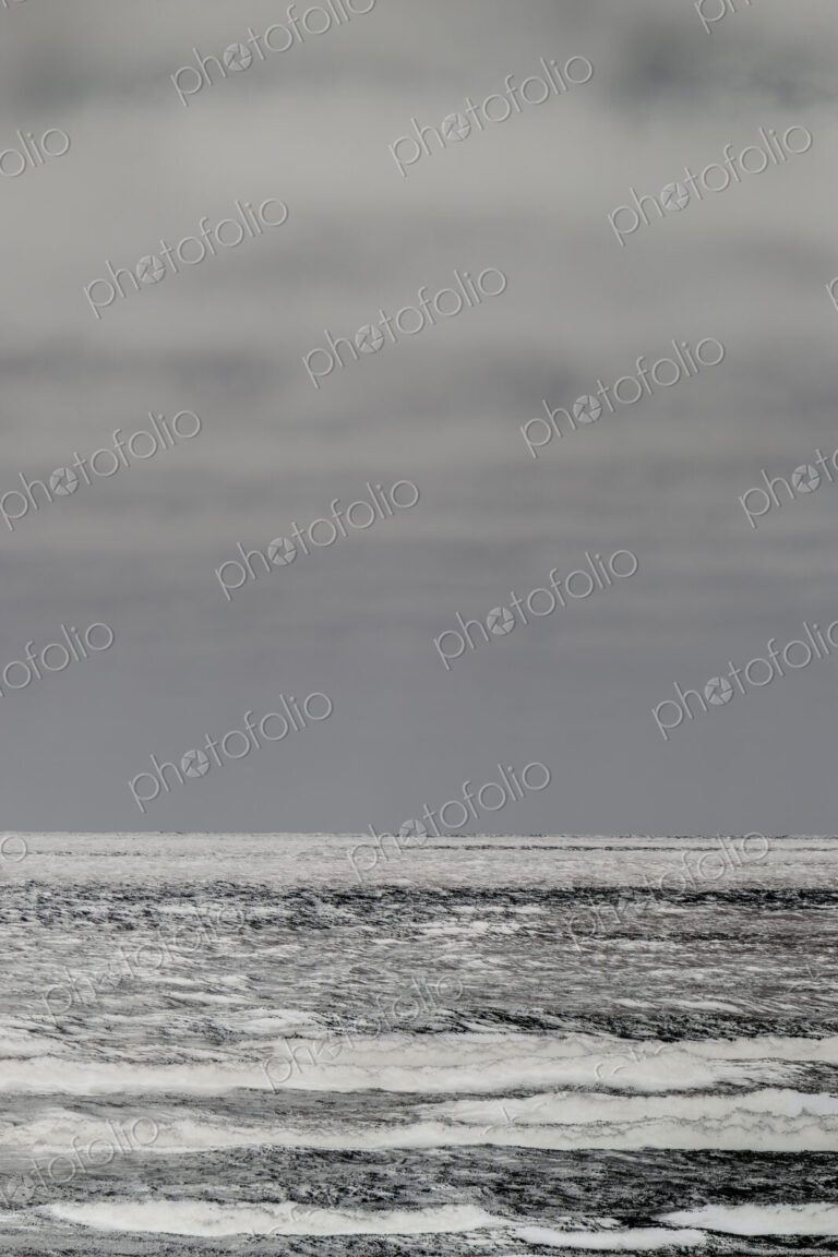 Breaking waves and moody sky at dusk