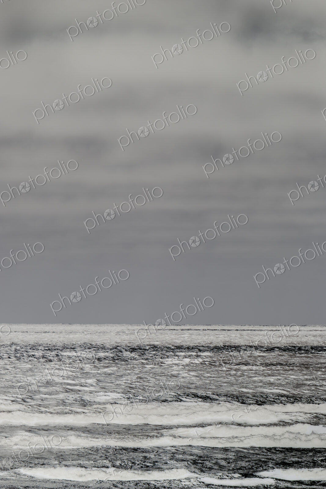 Breaking waves and moody sky at dusk