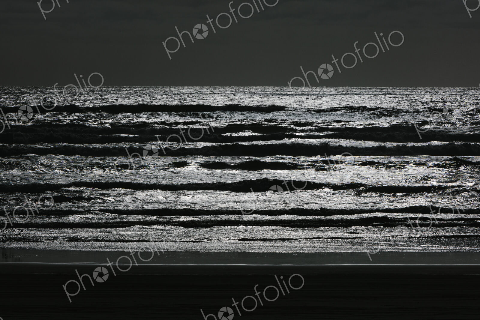 Breaking waves and moody sky at dusk