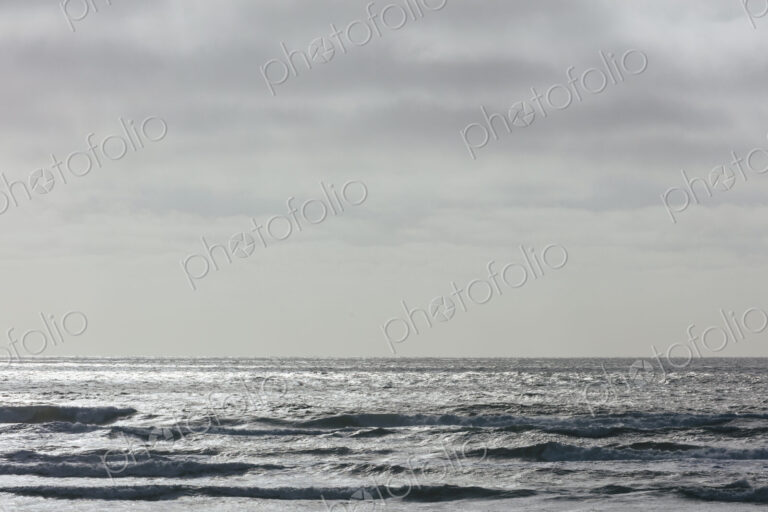 Breaking waves and moody sky at dusk