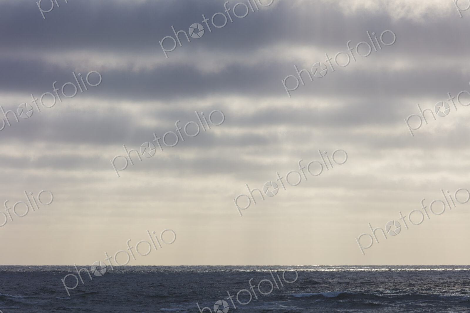 Breaking waves and moody sky at dusk