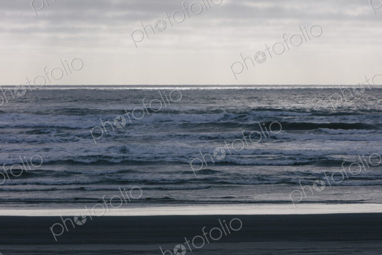 Breaking waves and moody sky at dusk