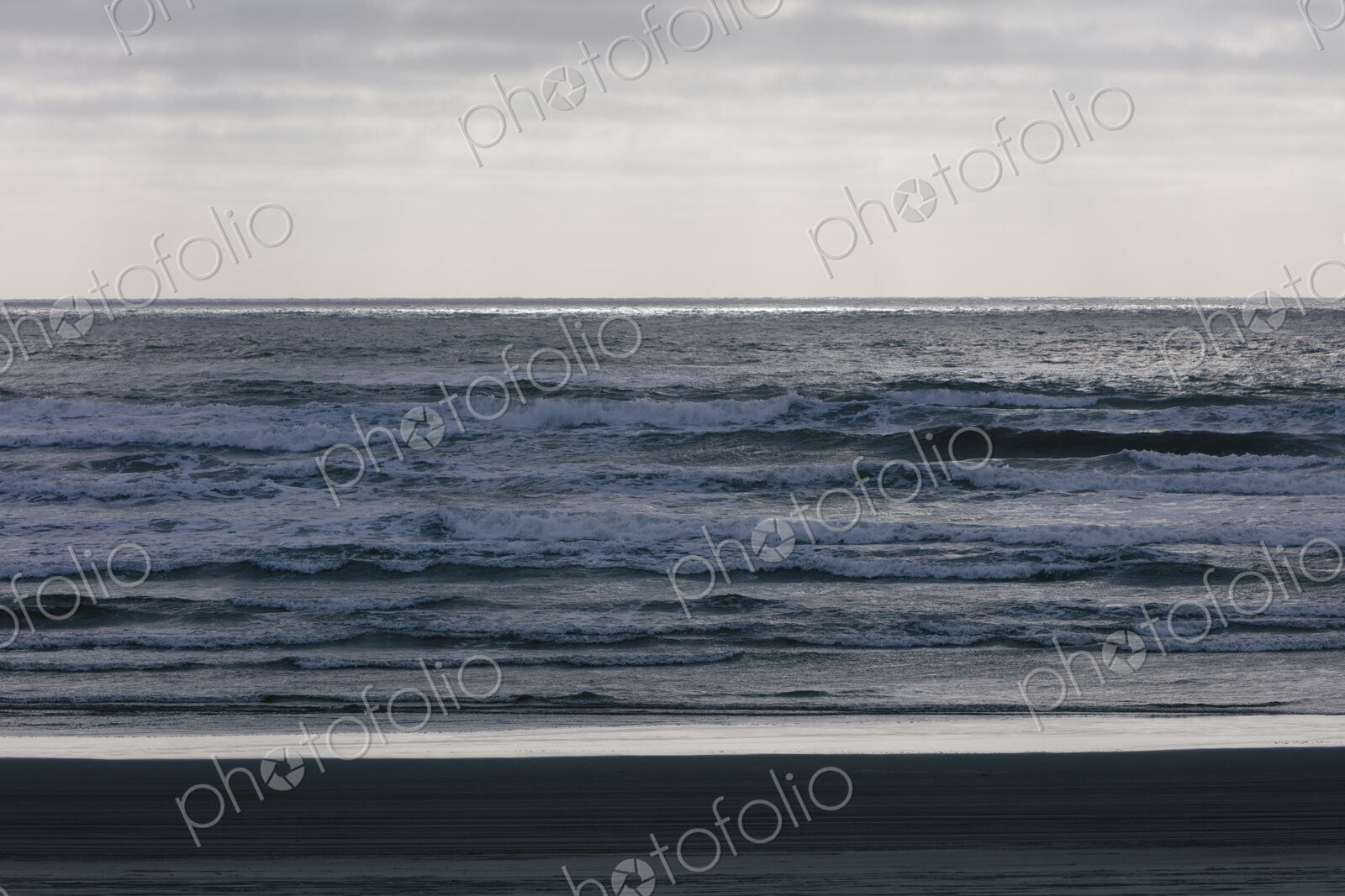 Breaking waves and moody sky at dusk