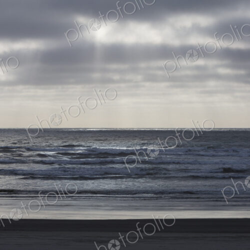 Breaking waves and moody sky at dusk Breaking waves and moody sky at dusk
