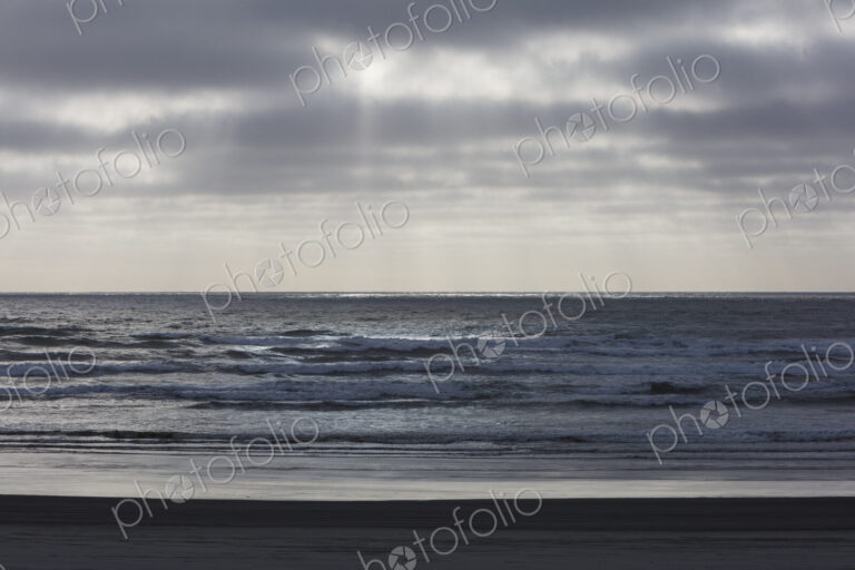 Breaking waves and moody sky at dusk