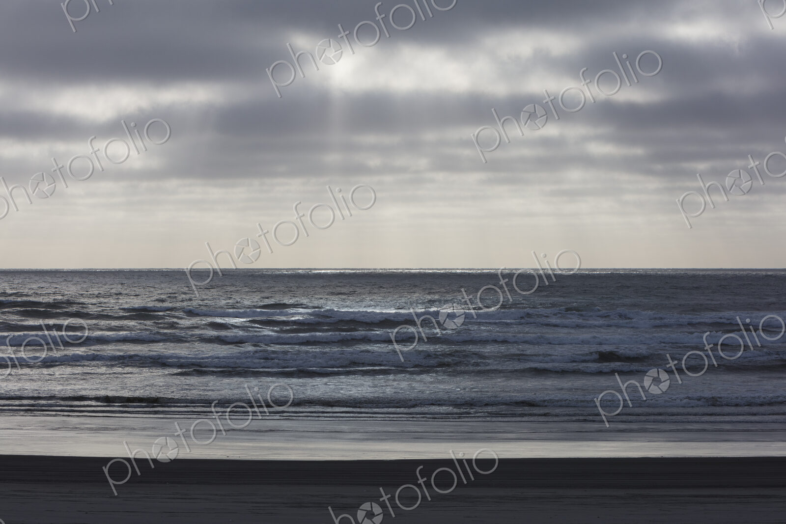Breaking waves and moody sky at dusk