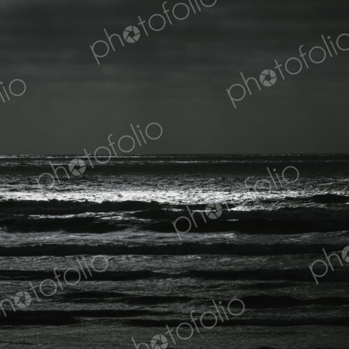 Breaking waves and moody sky at dusk Breaking waves and moody sky at dusk